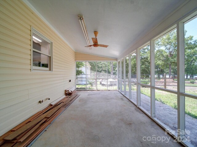 unfurnished sunroom with ceiling fan and lofted ceiling