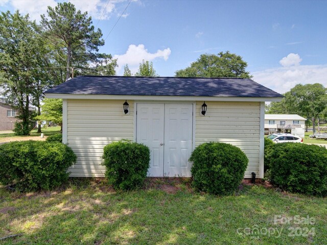 view of outbuilding with a lawn