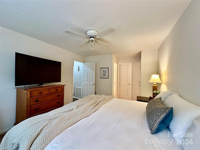 bedroom featuring a textured ceiling and ceiling fan