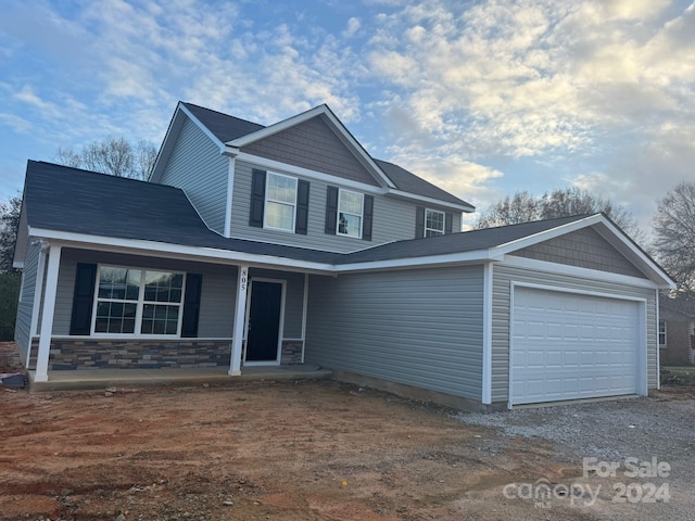 view of front of home with a porch and a garage