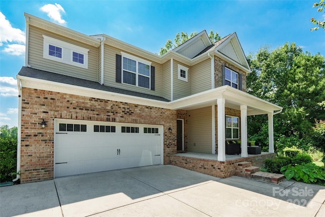 craftsman inspired home with covered porch and a garage