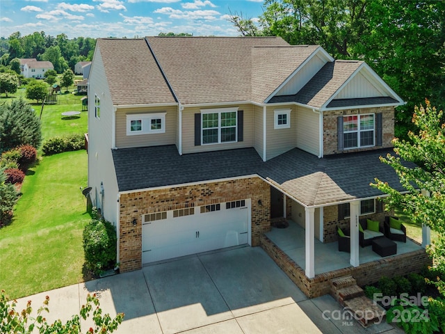 view of front of property with a garage and a front lawn