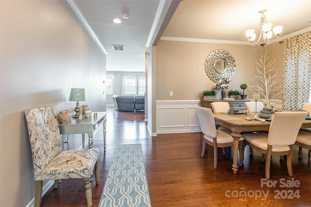 dining space with an inviting chandelier, dark wood-type flooring, and ornamental molding