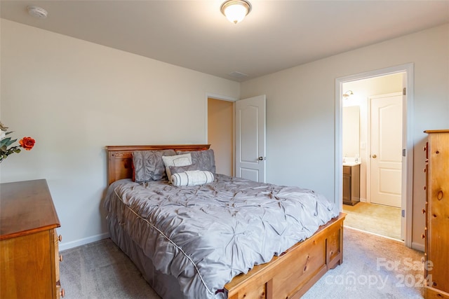 carpeted bedroom with ensuite bath