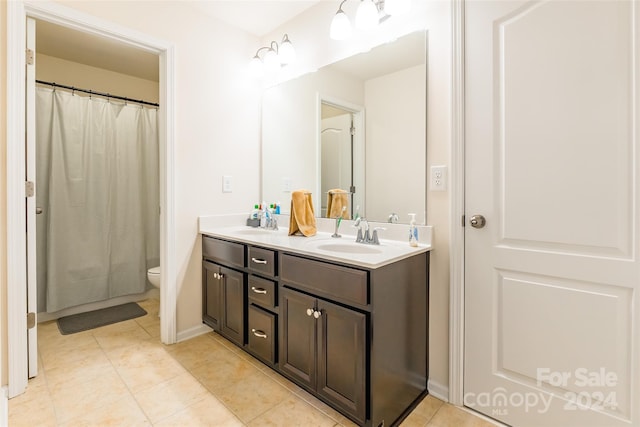 bathroom featuring tile patterned floors, vanity, and toilet