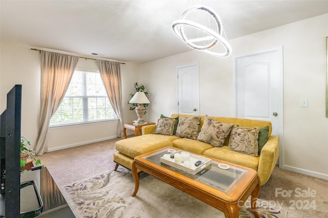 living room with carpet and a chandelier