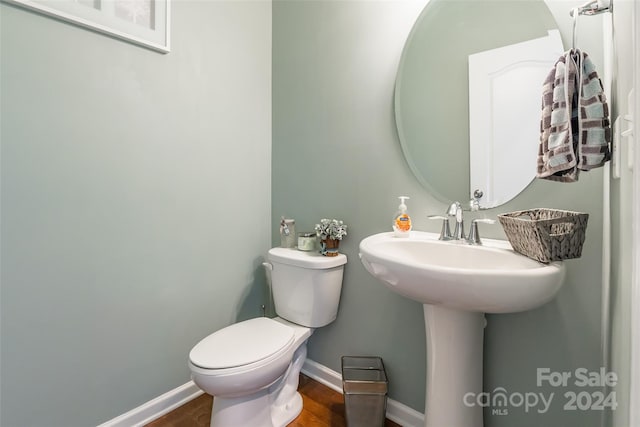 bathroom featuring hardwood / wood-style flooring and toilet