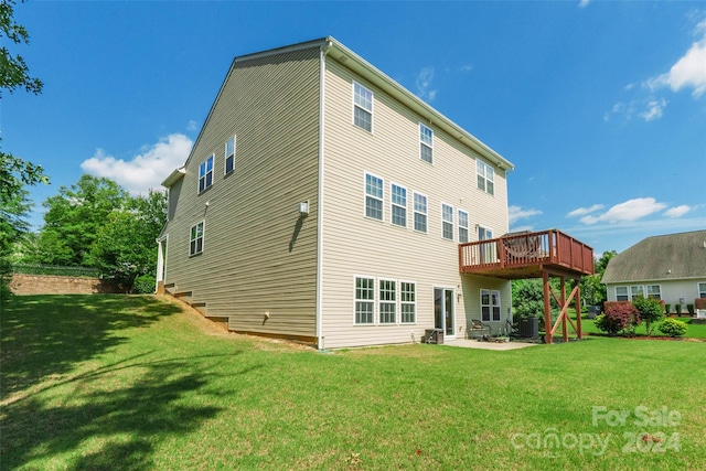 back of property featuring a yard, a patio, cooling unit, and a wooden deck