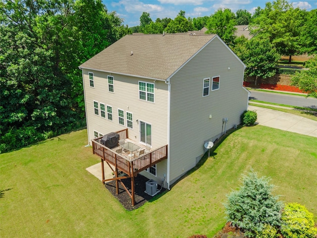 back of house with a yard, a deck, and central air condition unit