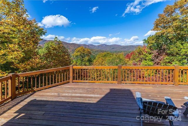 wooden deck with a mountain view