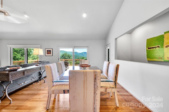 dining area featuring light wood-type flooring, a wealth of natural light, and lofted ceiling