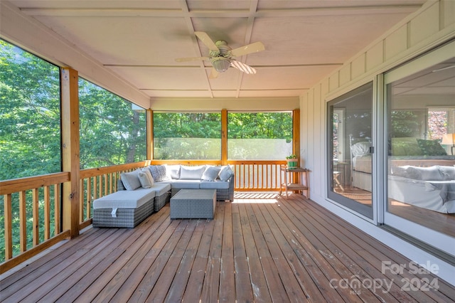 sunroom / solarium featuring ceiling fan