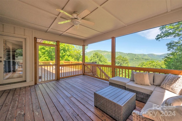 wooden deck featuring a mountain view, an outdoor hangout area, and ceiling fan