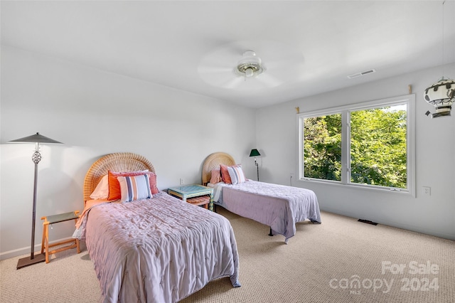 bedroom with ceiling fan and light carpet