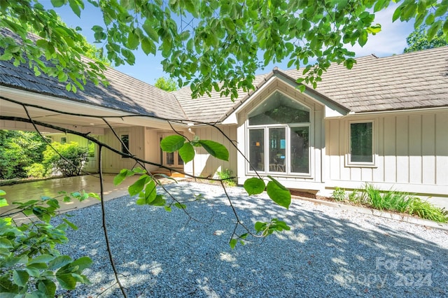 back of property featuring a carport