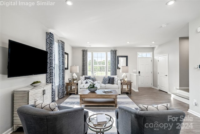 living room with recessed lighting, baseboards, and wood finished floors