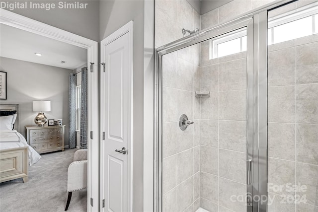 ensuite bathroom featuring a stall shower and connected bathroom