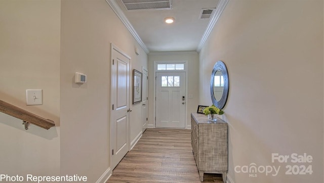 entryway featuring crown molding and light wood-type flooring