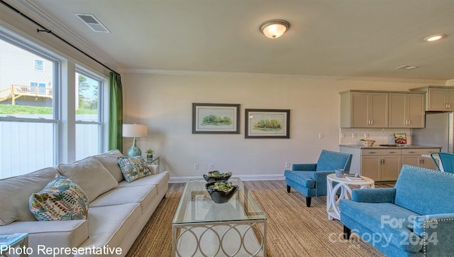 living room featuring light wood-type flooring and crown molding