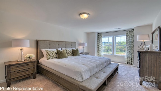 bedroom featuring light carpet