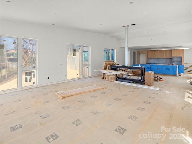 living area with plenty of natural light and lofted ceiling
