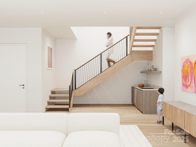 stairway with recessed lighting and wood finished floors