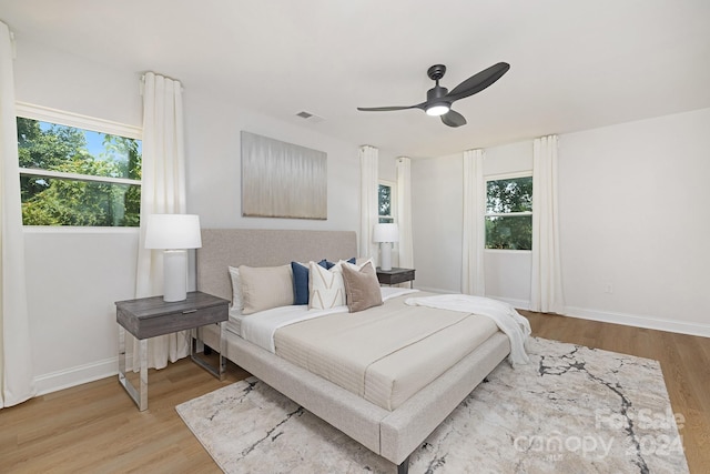 bedroom with light wood-type flooring and ceiling fan