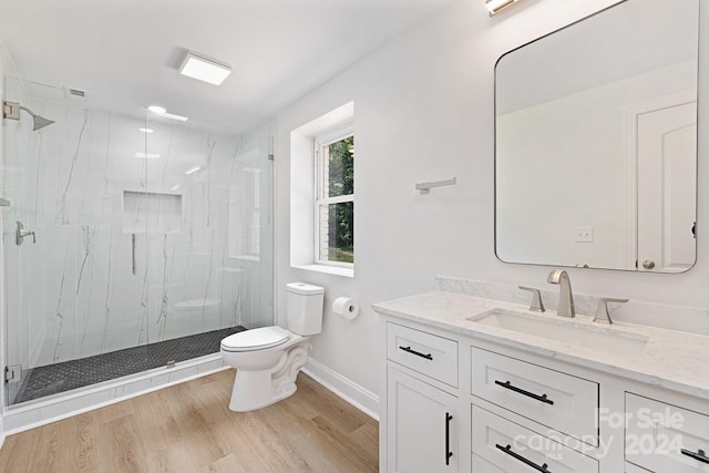 bathroom featuring vanity, a shower with shower door, toilet, wood-type flooring, and washer / clothes dryer