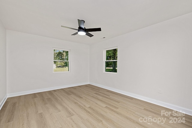 unfurnished room with ceiling fan and light wood-type flooring