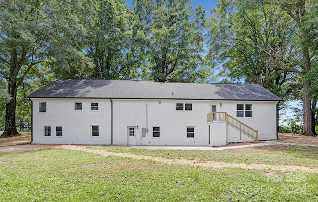 rear view of property featuring a yard