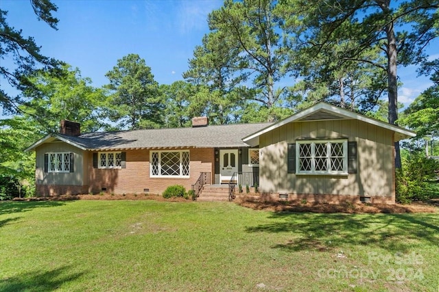 ranch-style home featuring a front yard