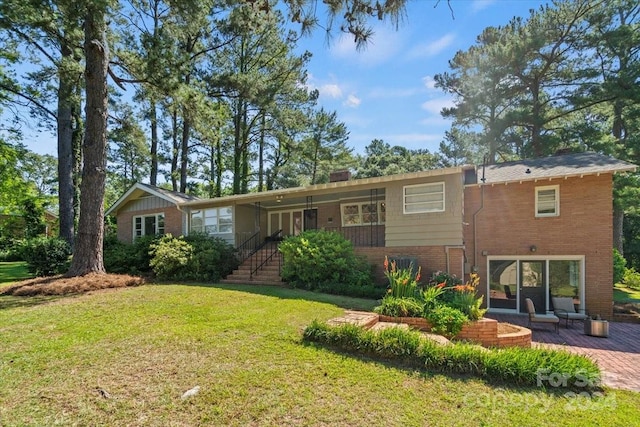 view of front of property with a patio area and a front lawn