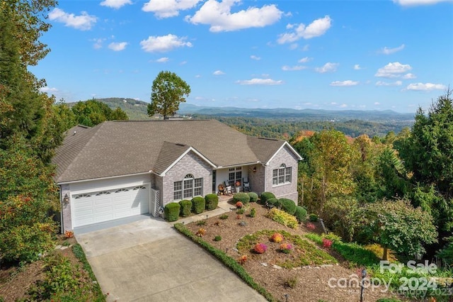 ranch-style house featuring a mountain view and a garage