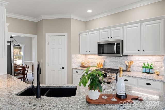 kitchen featuring sink, white cabinets, and appliances with stainless steel finishes