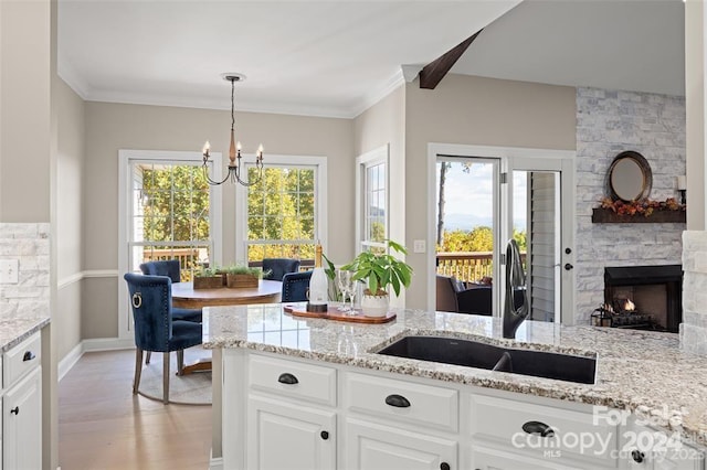 kitchen featuring white cabinets, sink, and a wealth of natural light