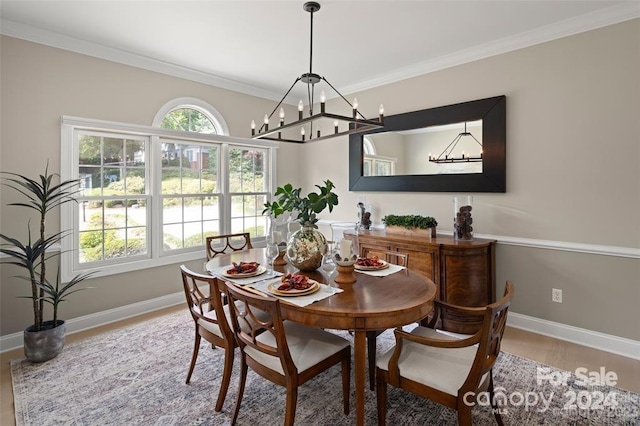 dining space featuring crown molding, a notable chandelier, and hardwood / wood-style flooring