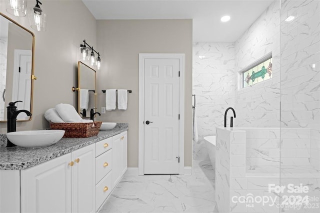 bathroom featuring a tile shower and vanity