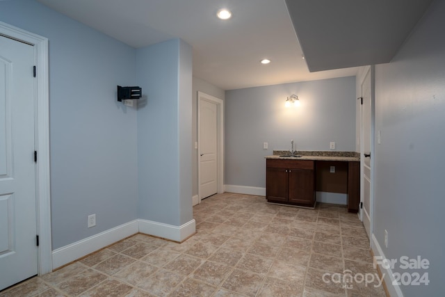 interior space featuring dark brown cabinets and sink