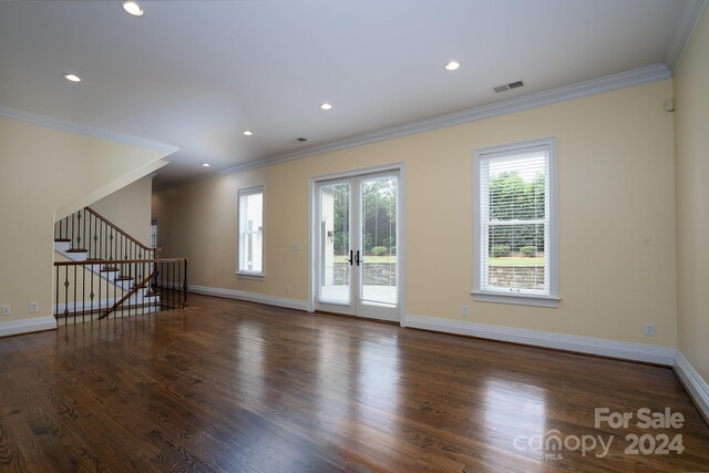 spare room with dark hardwood / wood-style floors, crown molding, and french doors