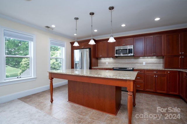 kitchen with a kitchen bar, pendant lighting, a center island, and stainless steel appliances