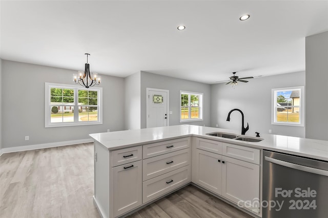 kitchen featuring dishwasher, light wood-type flooring, white cabinetry, and sink