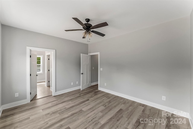 unfurnished bedroom with ceiling fan and light hardwood / wood-style flooring