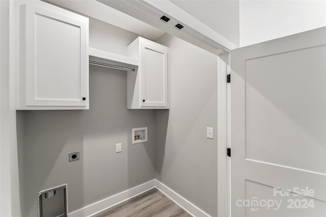 laundry area featuring washer hookup, hookup for an electric dryer, cabinets, and light hardwood / wood-style flooring