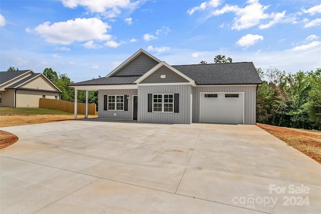 view of front of house with covered porch and a garage