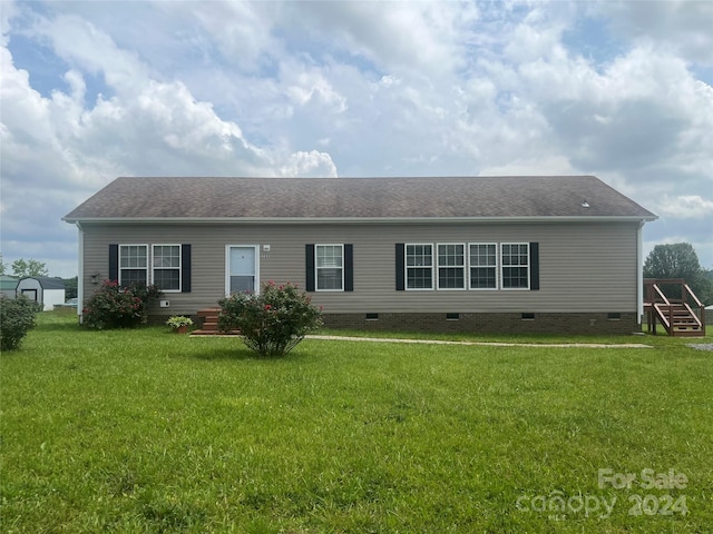 rear view of property with a lawn