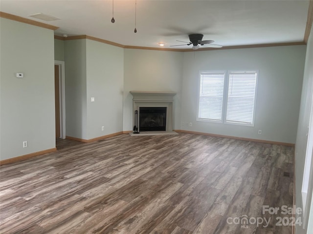 unfurnished living room featuring ceiling fan, hardwood / wood-style floors, and ornamental molding