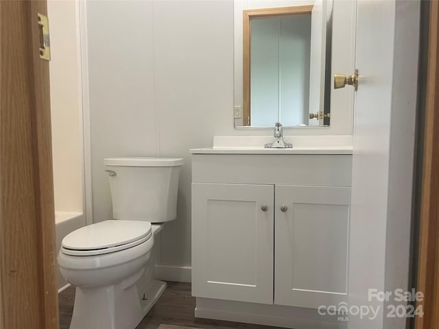 200 Olin Loop, Olin, NC 28660 - bathroom featuring toilet, vanity, wood-type flooring, and a washtub