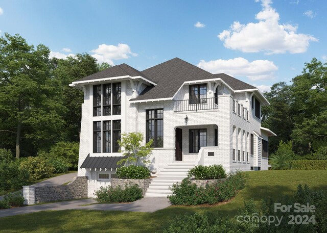 view of front of house with a balcony, a garage, and a front yard