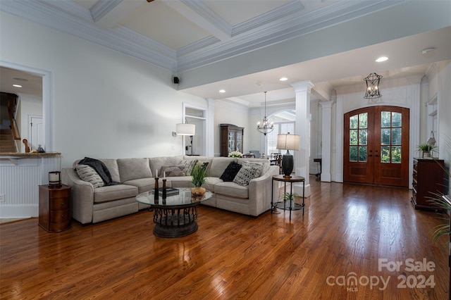 living room with a notable chandelier, beam ceiling, wood-type flooring, coffered ceiling, and decorative columns