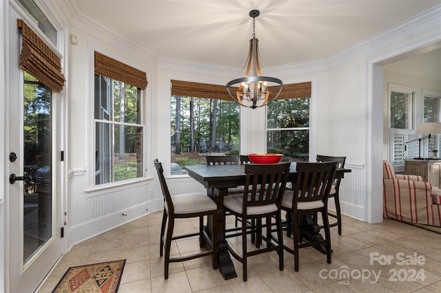 dining room with light tile patterned flooring, a notable chandelier, and ornamental molding